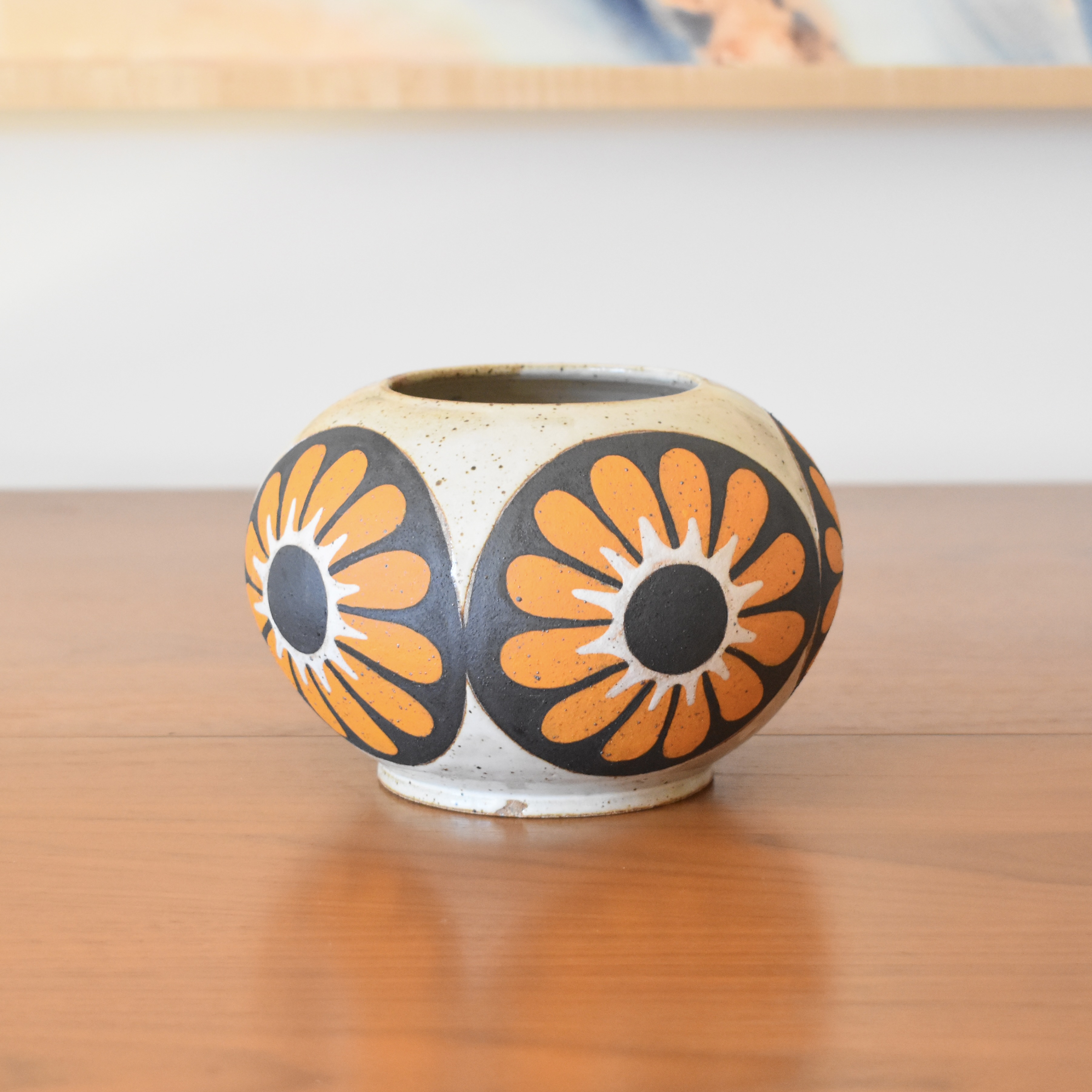 Wheelthrown with stoneware and painted with non-toxic underglazes. Outer lip and interior glazed in a heavily freckled glossy white/brown glaze. 4.5" tall, 3.5" opening, and overall width of 6".
