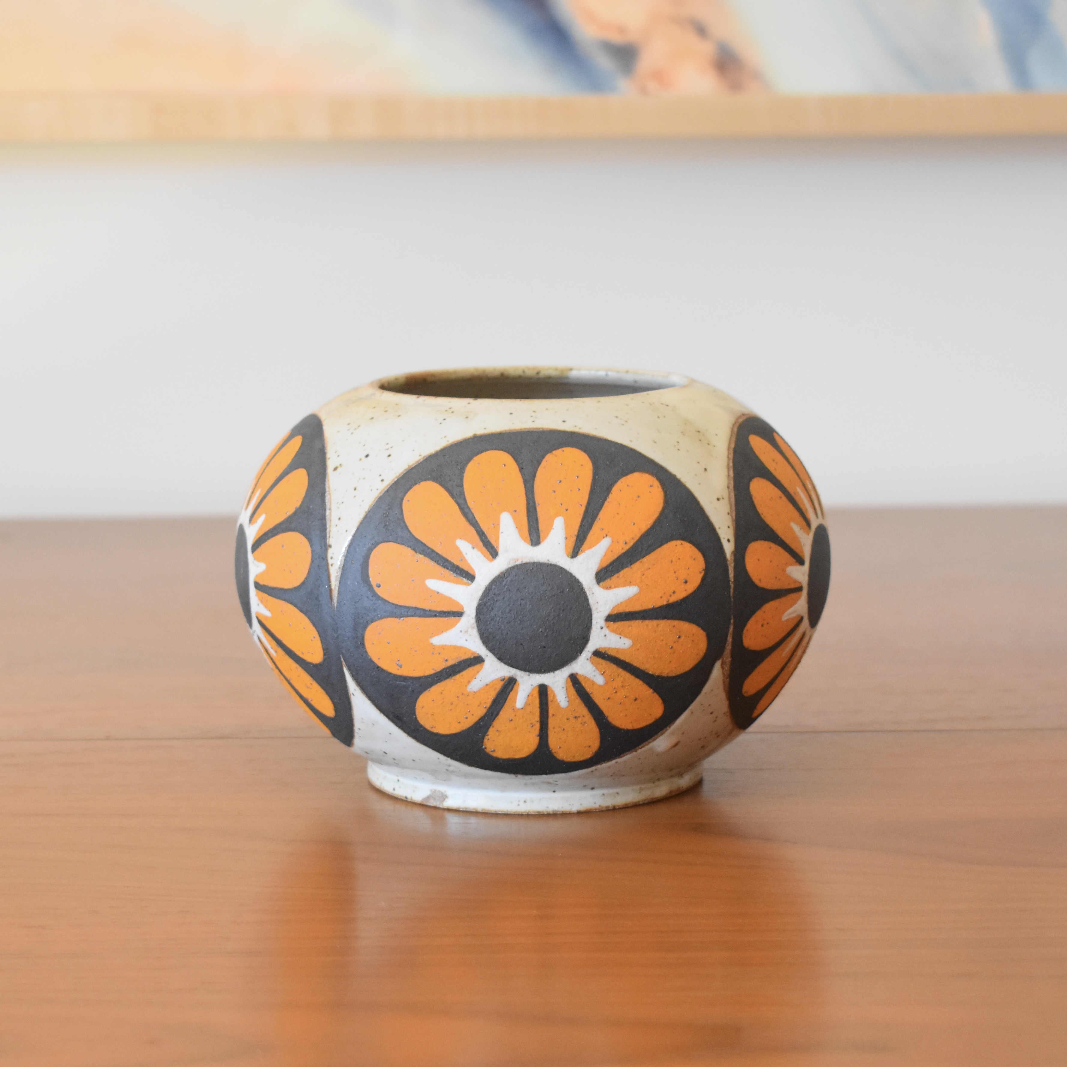 Wheelthrown with stoneware and painted with non-toxic underglazes. Outer lip and interior glazed in a heavily freckled glossy white/brown glaze. 4.5" tall, 3.5" opening, and overall width of 6".