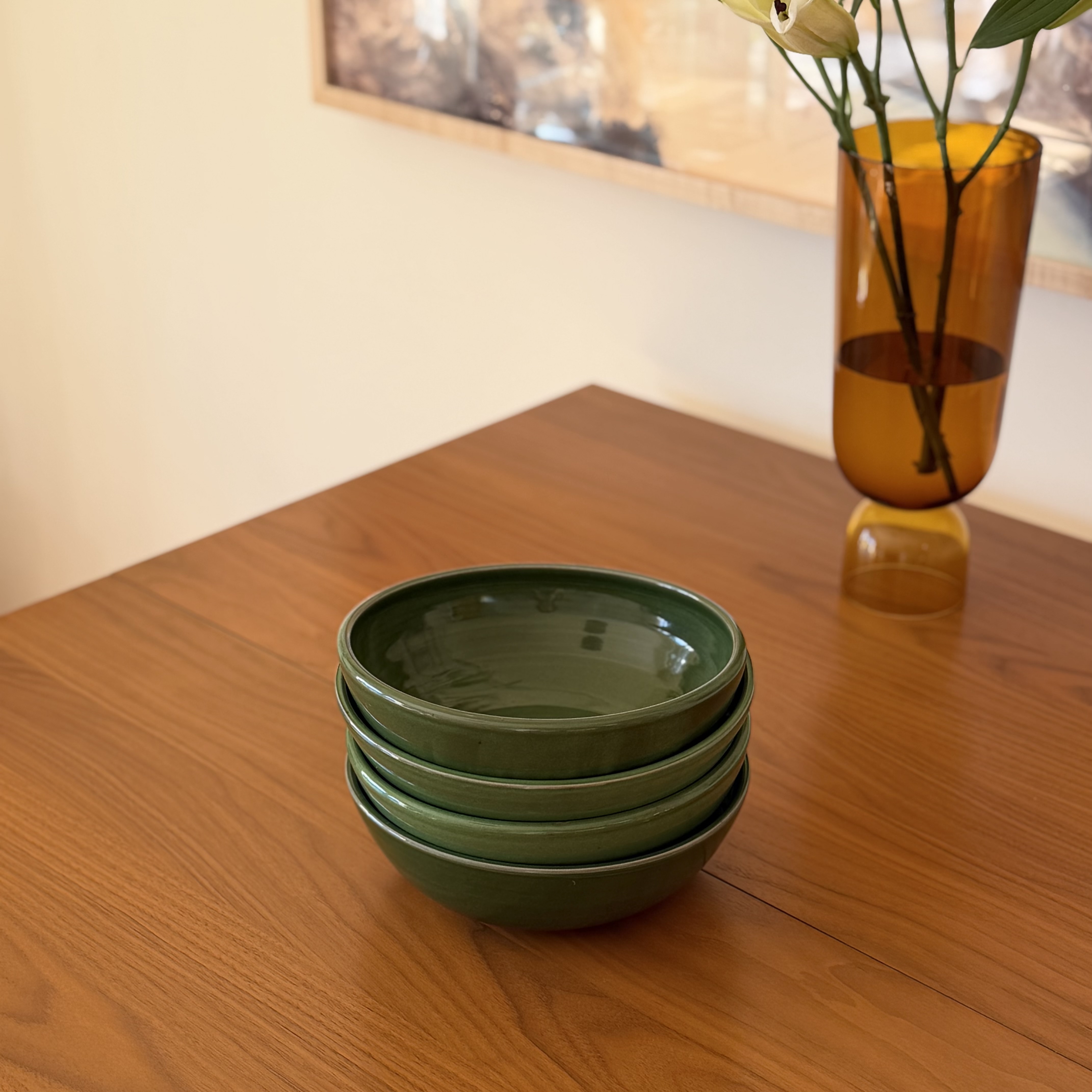 Wheelthrown with stoneware. Glazed in a bright glossy green. Measure 8" wide x 2.75" tall. Sold as a set of 4. Please allow for slight variation in glaze and size as each piece is handmade. 