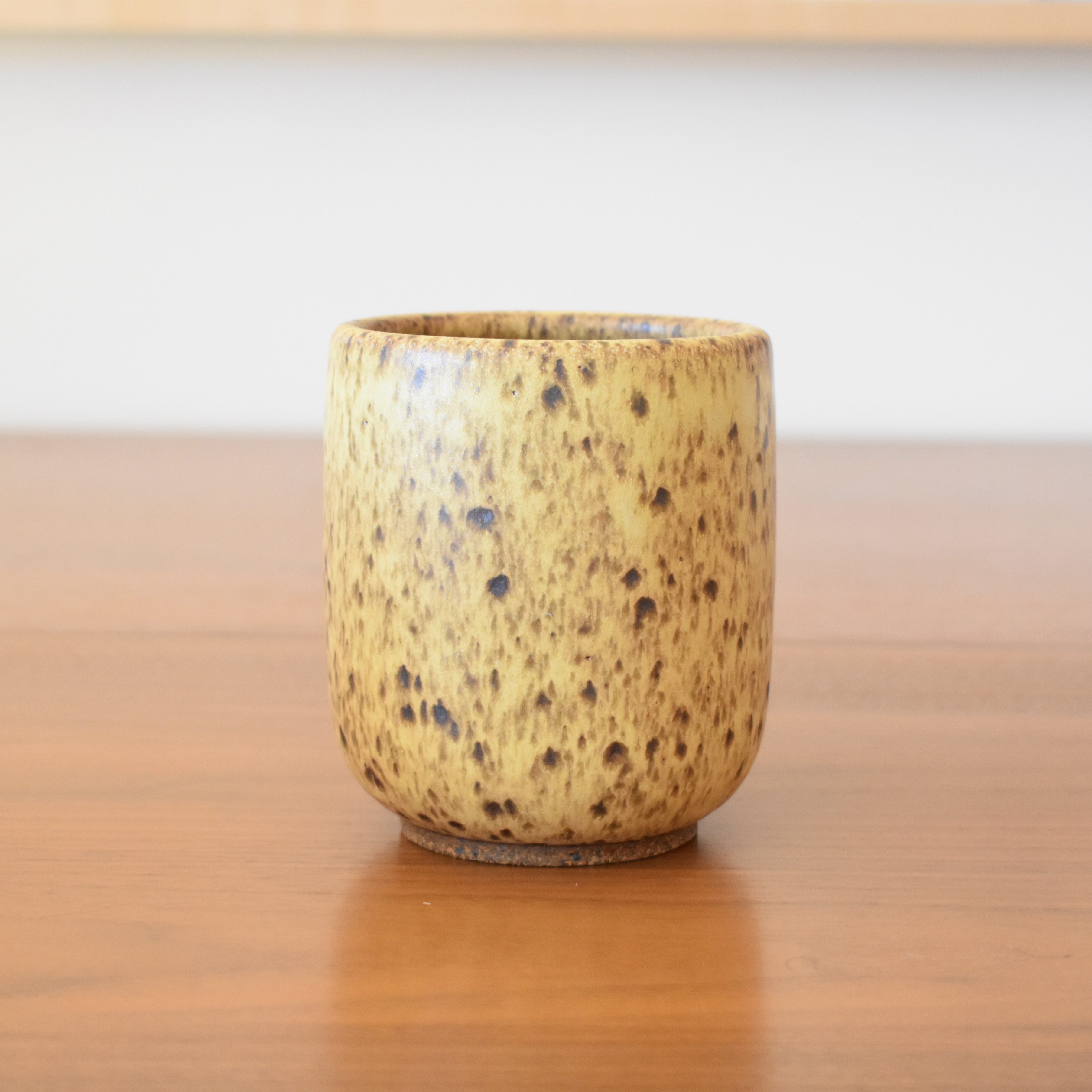 Wheelthrown with stoneware. Glazed in a v-ripe-banana-like glaze. 3.25" wide x 4" tall. Holds approximately 14 fl oz.