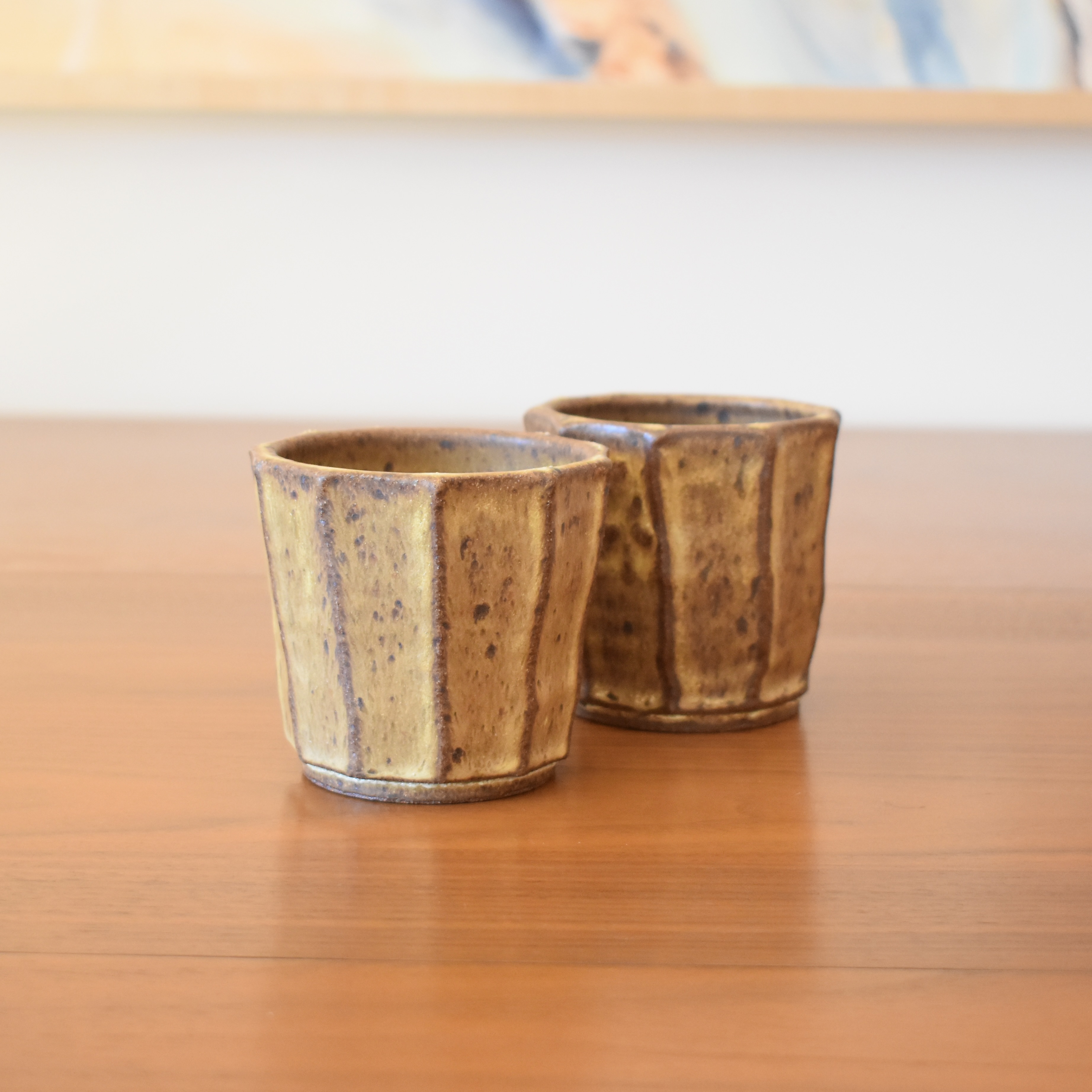 Wheelthrown with stoneware and then hand carved for a faceted look. Glazed in a glossy black / green. 3.5" wide x 3.5" tall. Hold approximately 12 fl oz. 