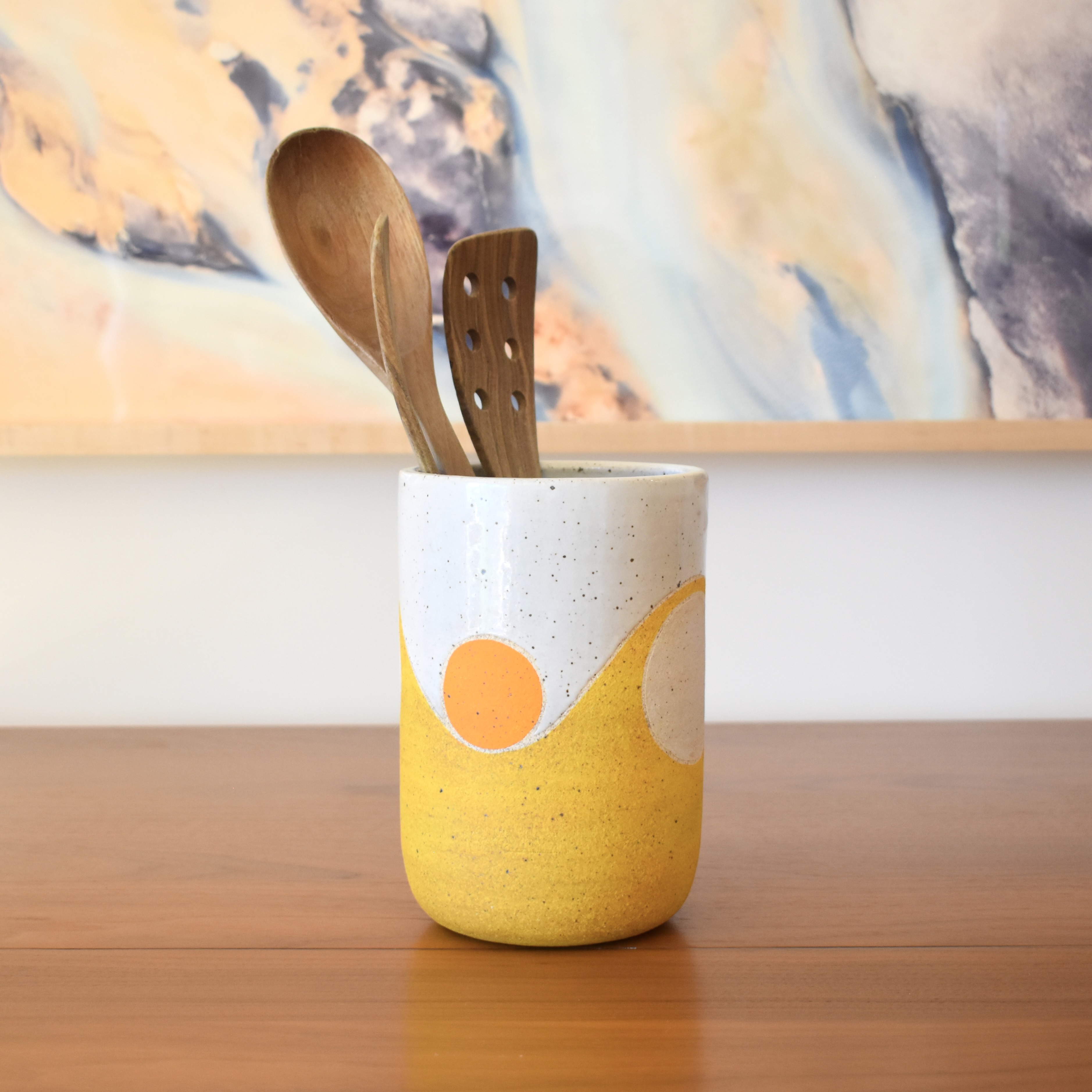 Wheelthrown with stoneware and hand-painted using non-toxic underglazes and a white glossy glaze. Measures 5" wide x 7" tall.