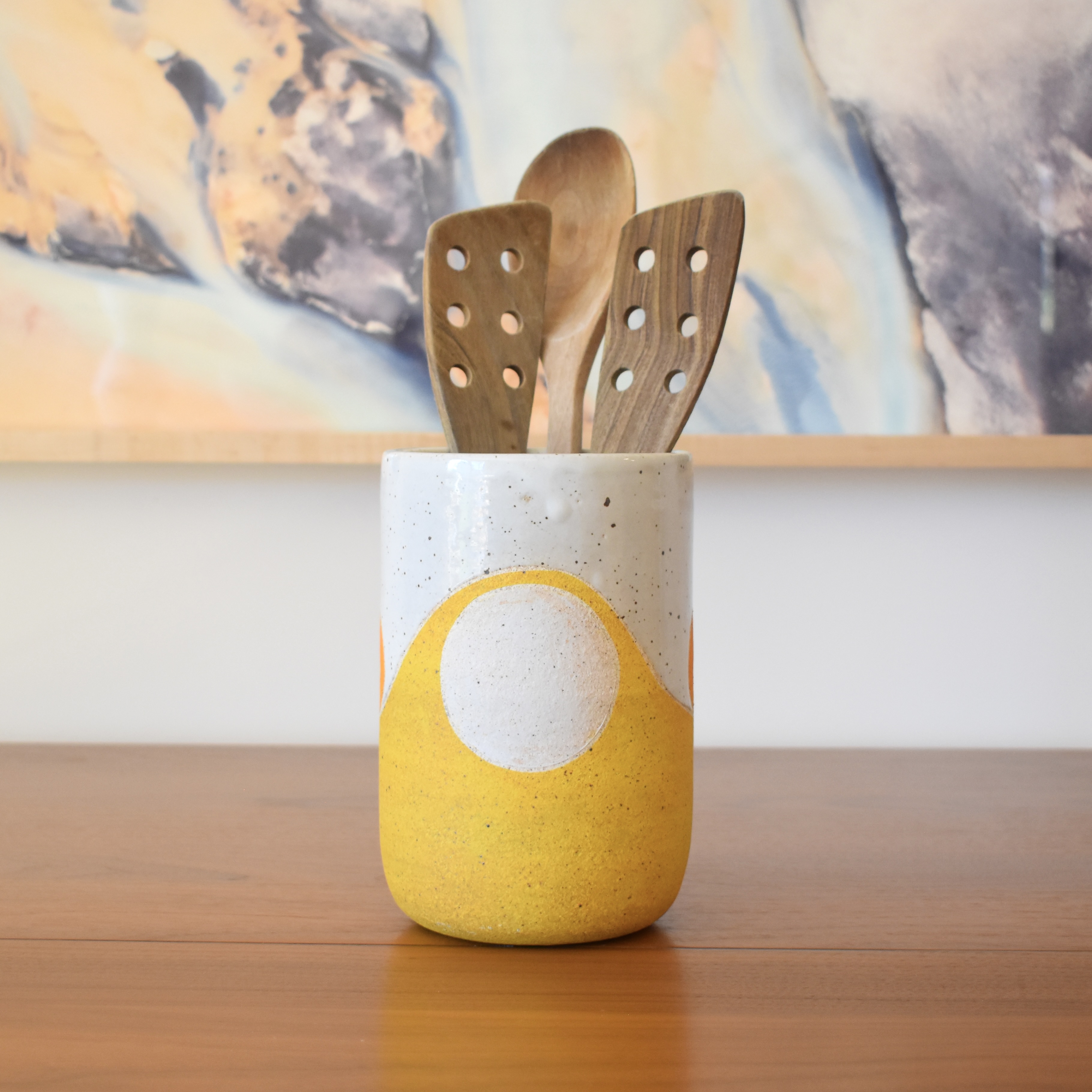 Wheelthrown with stoneware and hand-painted using non-toxic underglazes and a white glossy glaze. Measures 5" wide x 7" tall.