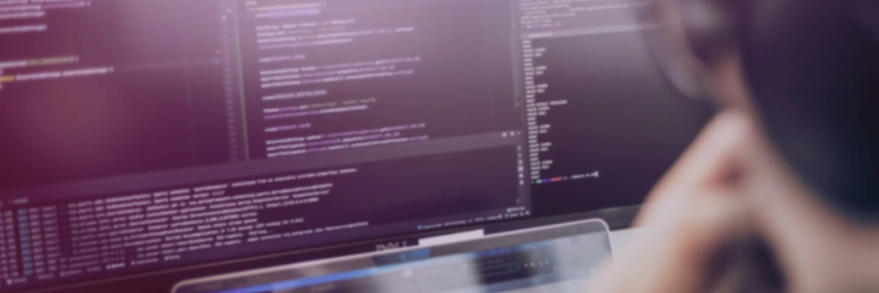 Developer with multiple screens working at the Funidata office