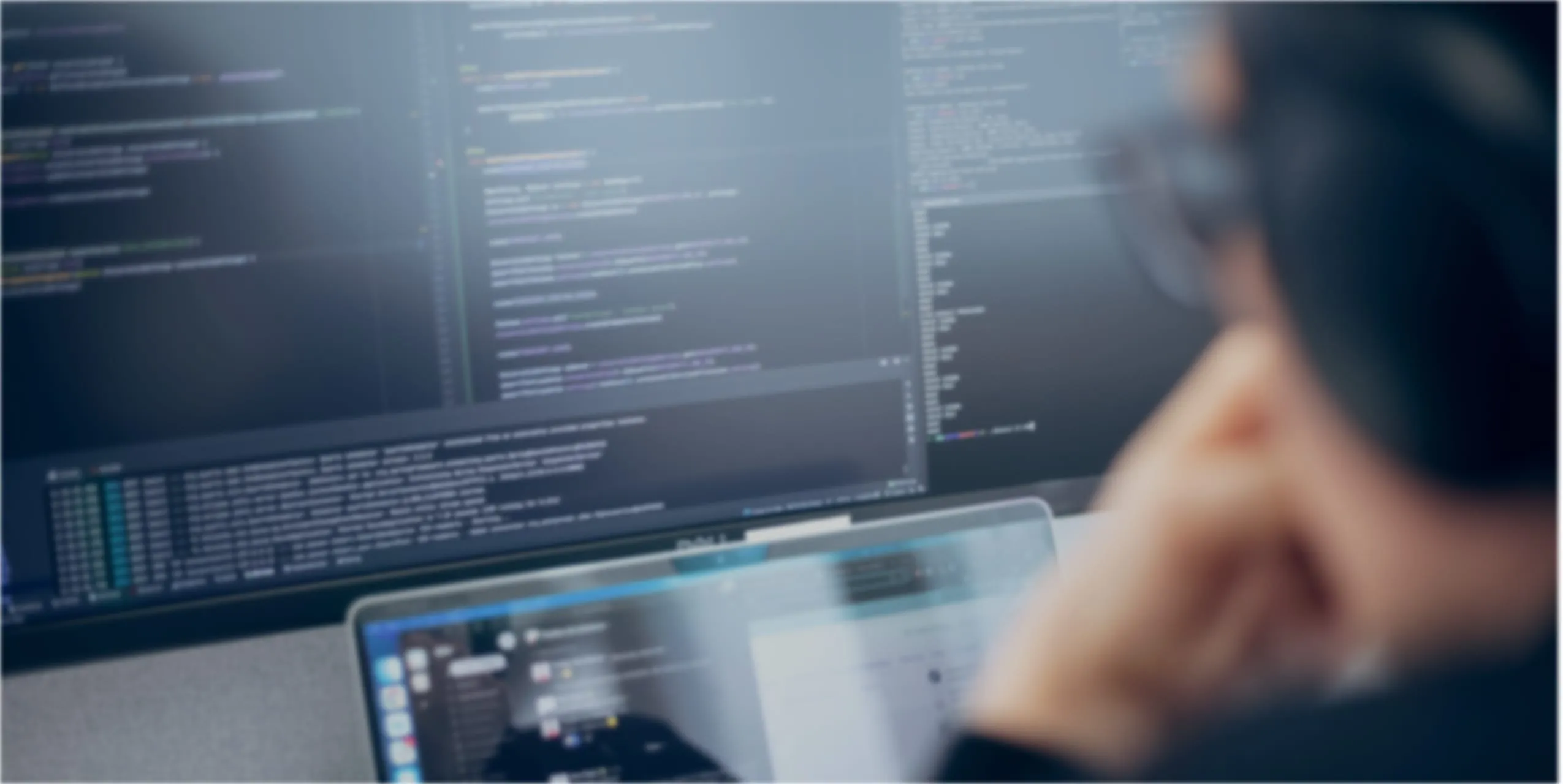 Developer with multiple screens working at the Funidata office