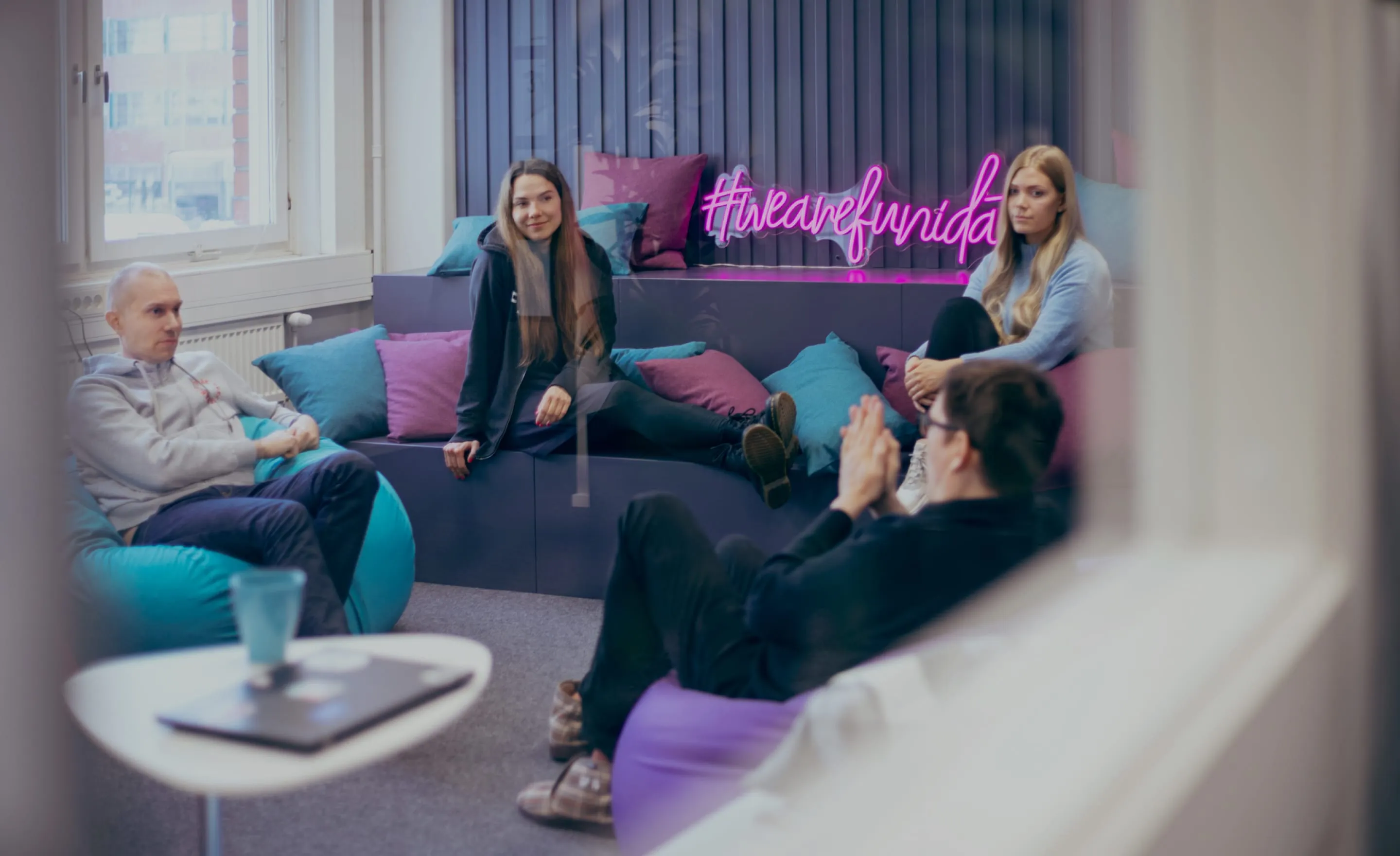 Four colleagues chilling in the Funidata lounge