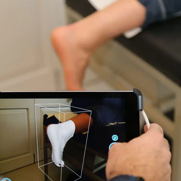 PICTURE OF FOOT BEING 3D SCANNED