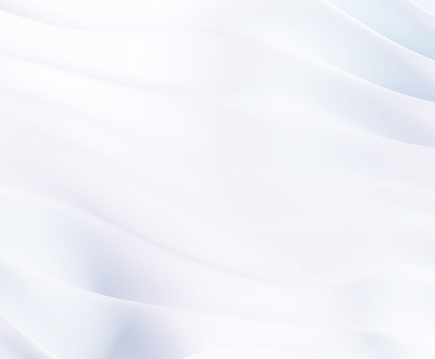 Softly folded white and pale blue fabric with smooth, gentle waves.