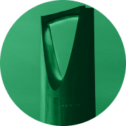 Tall, modern architectural structure with a large triangular cutout near the top against a clear sky.