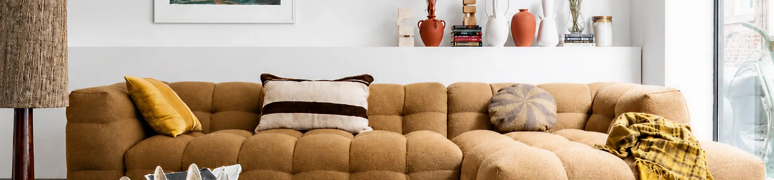 Living room of a London holiday let with a large tan sofa