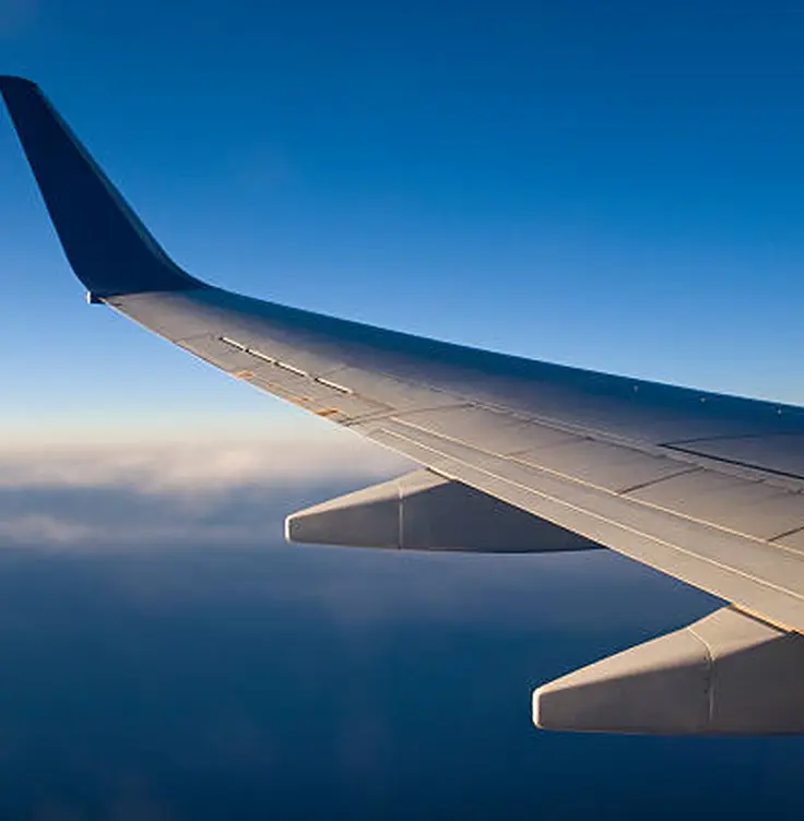 View of an aircraft wing above the clouds