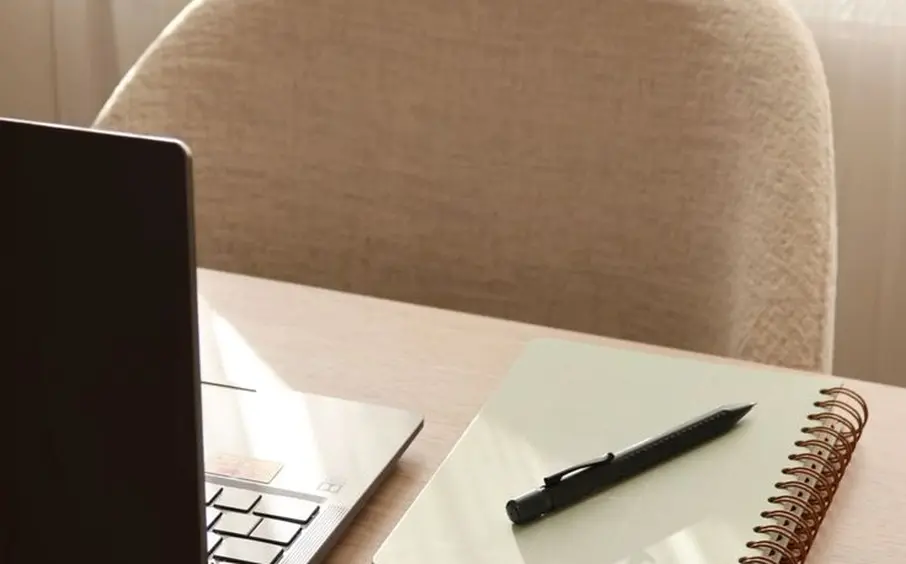Laptop and notebook on a desk
