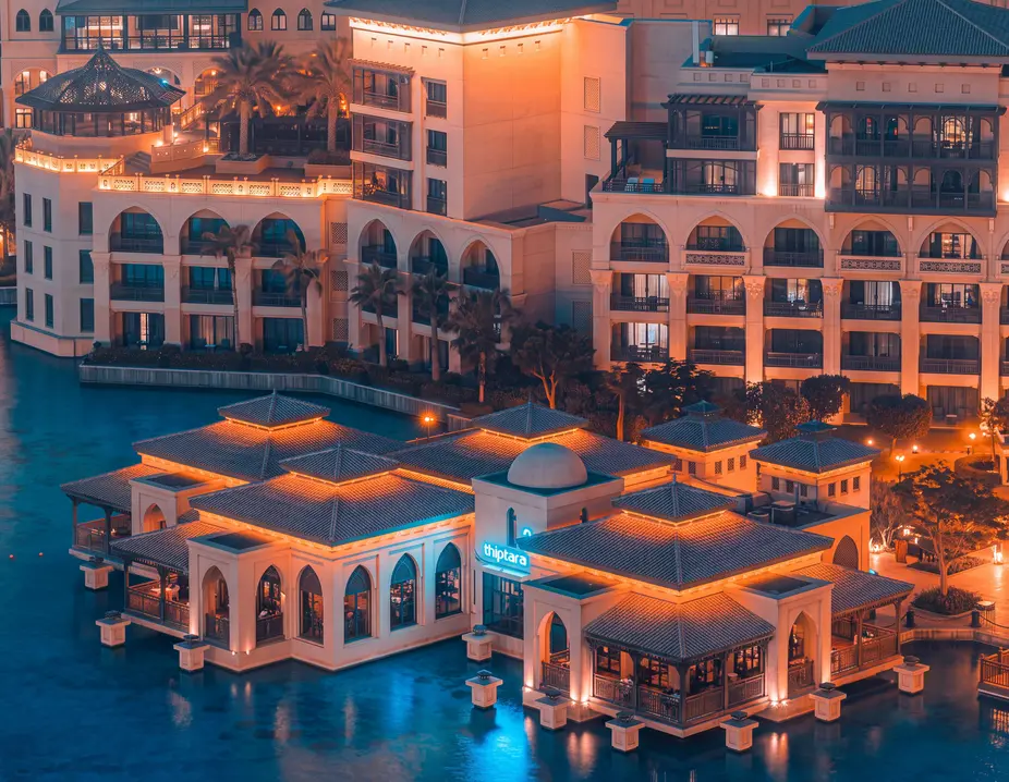 Low-rise Arabic-style buildings by the lake at dusk