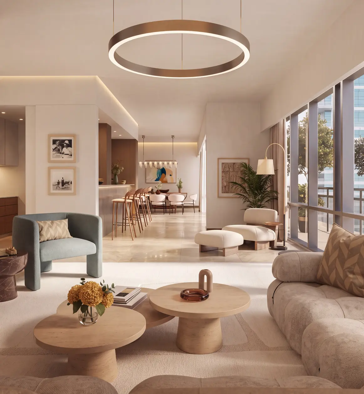Living room with a round pendant light, armchairs and a curved sofa