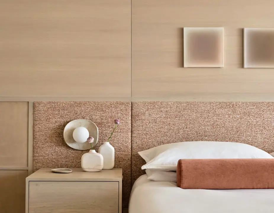 Bedroom with a wood-panelled wall and a bedside table