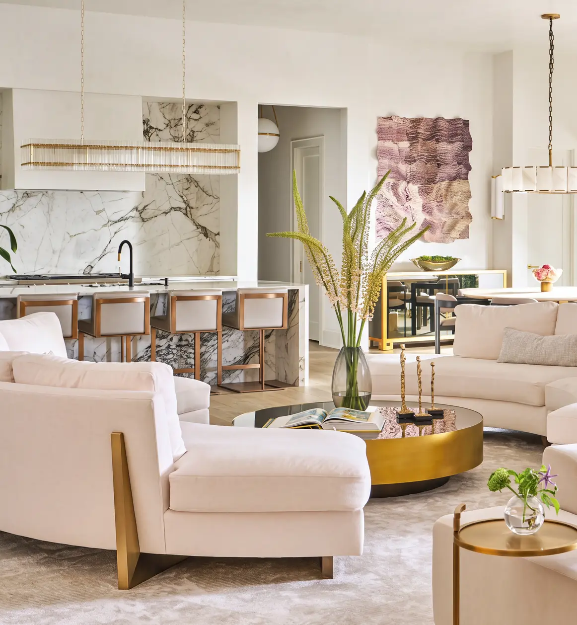 Living room with cream sofas and an open kitchen behind