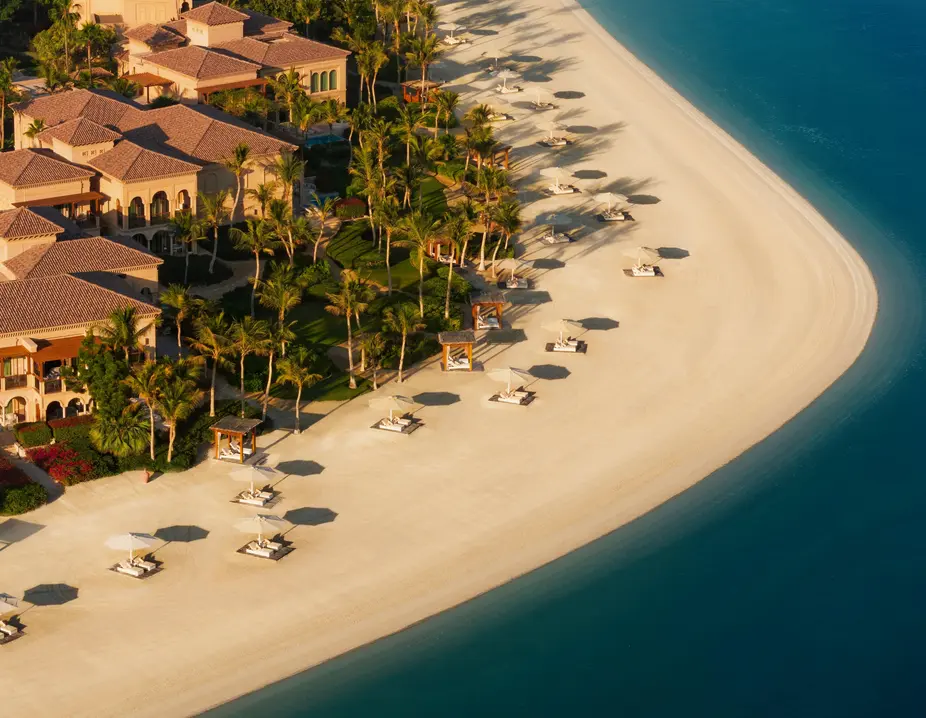 Villas and a sandy beach on a Palm Jumeirah frond from above