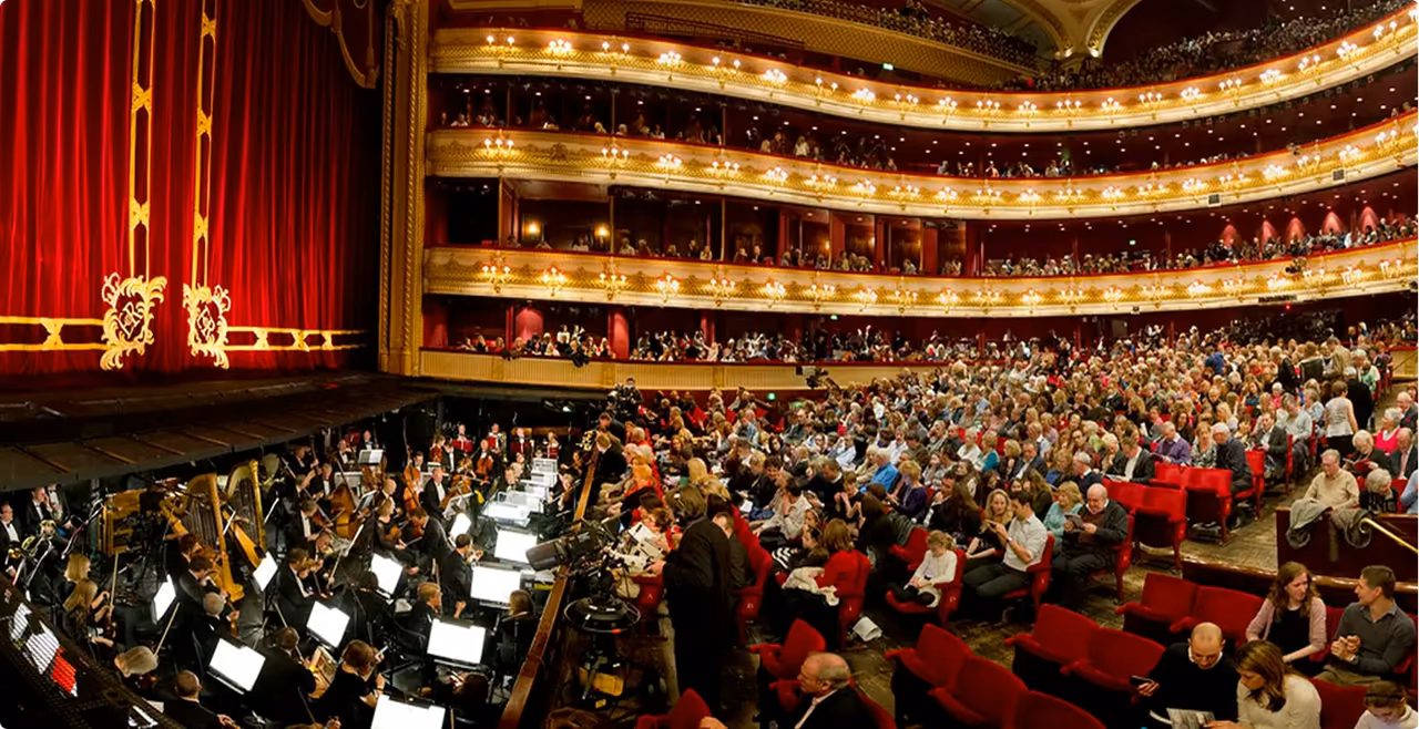 Red and gold Royal Opera House auditorium filled with an audience before a show