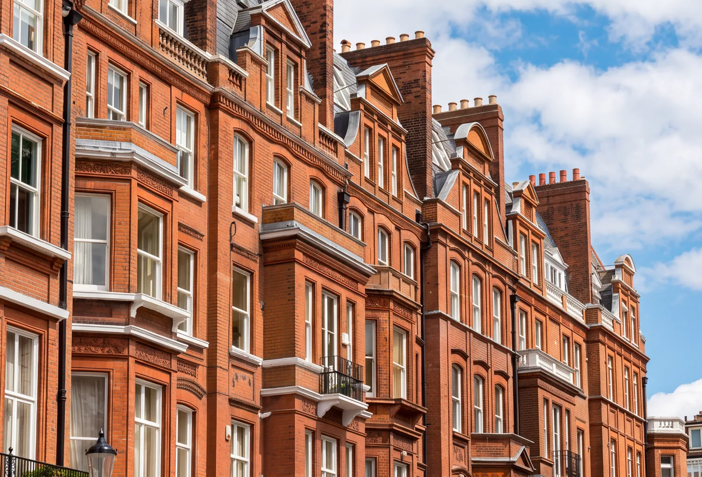 Red-brick Victorian mansion blocks on a London street