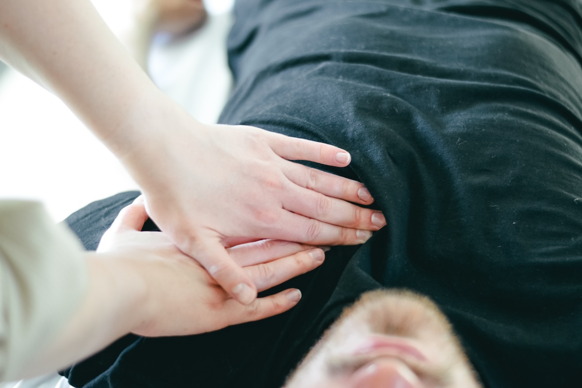 Rolfer’s hands on the upper chest of a client