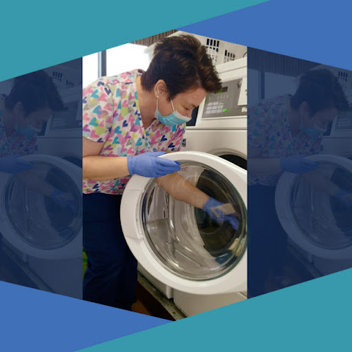 Home Keepers team member doing laundry