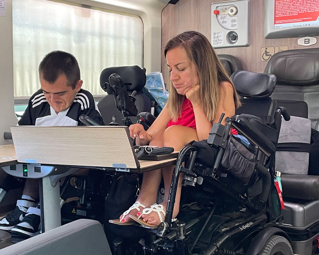 Natalie Russo and Jordan Dickey sitting on a train in Italy