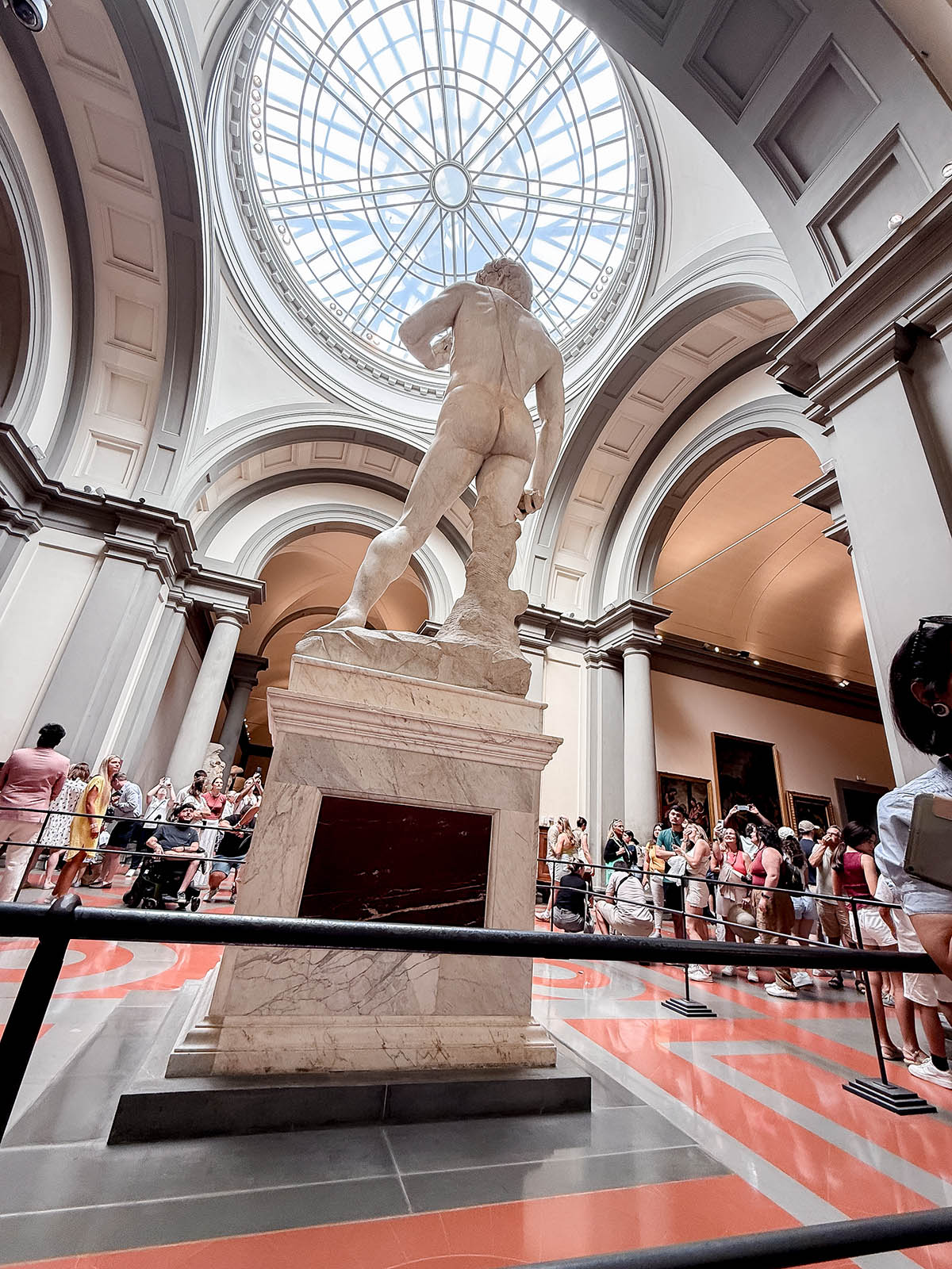Wheelchair user viewing exhibits at Florence Accademia Gallery