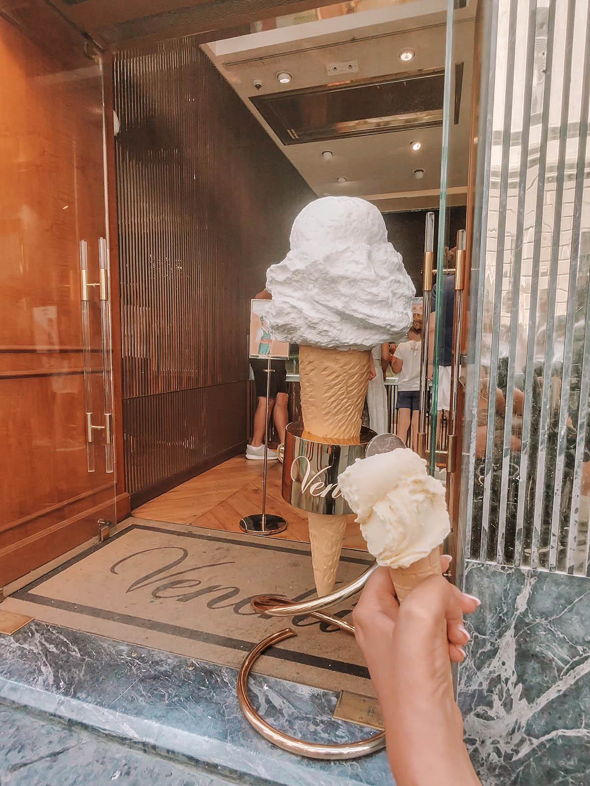 Holding a gelato cone in front of venchi