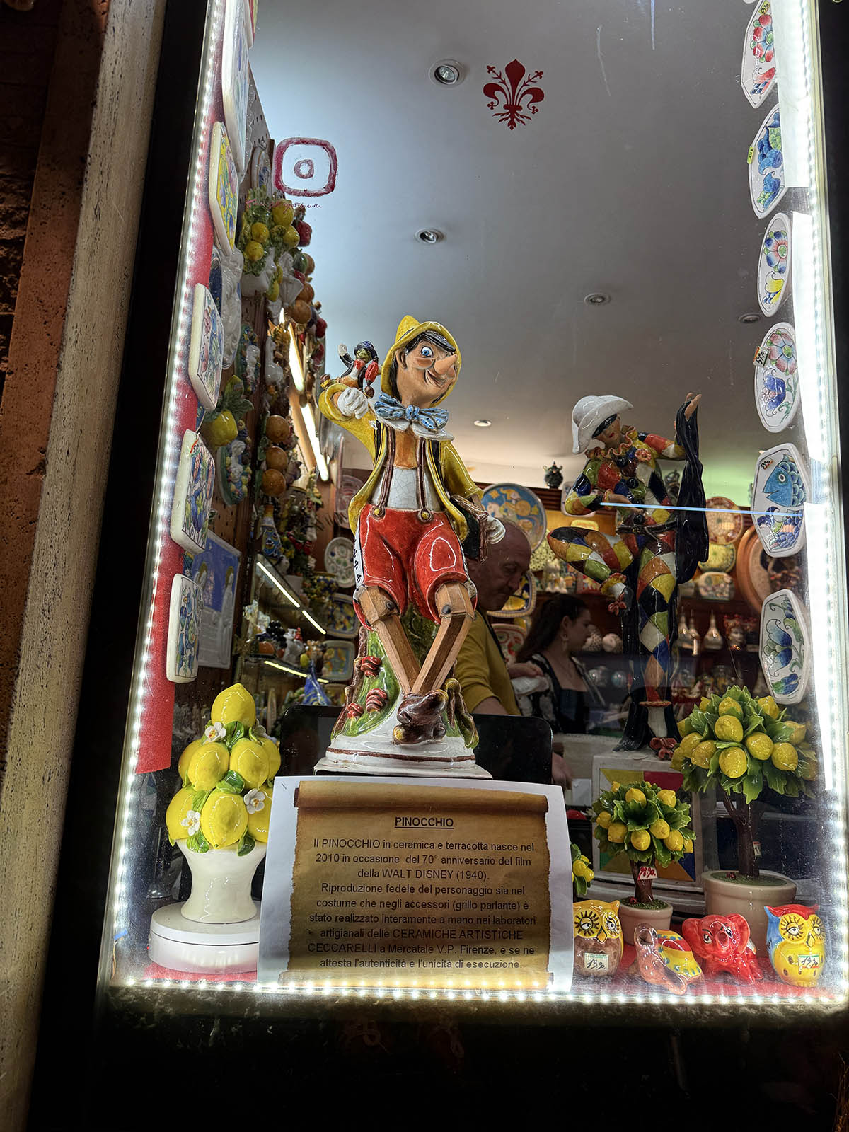 handmade pinocchio displayed in a window