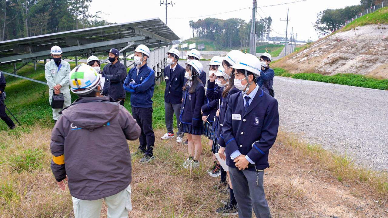 太陽光発電所を見学するSDGs部の生徒ら（afterFIT提供）