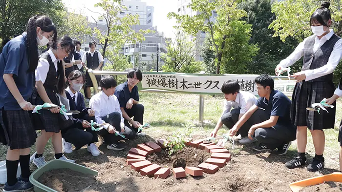クスノキの苗木を植樹する生徒たち＝撮影：水野拓昌