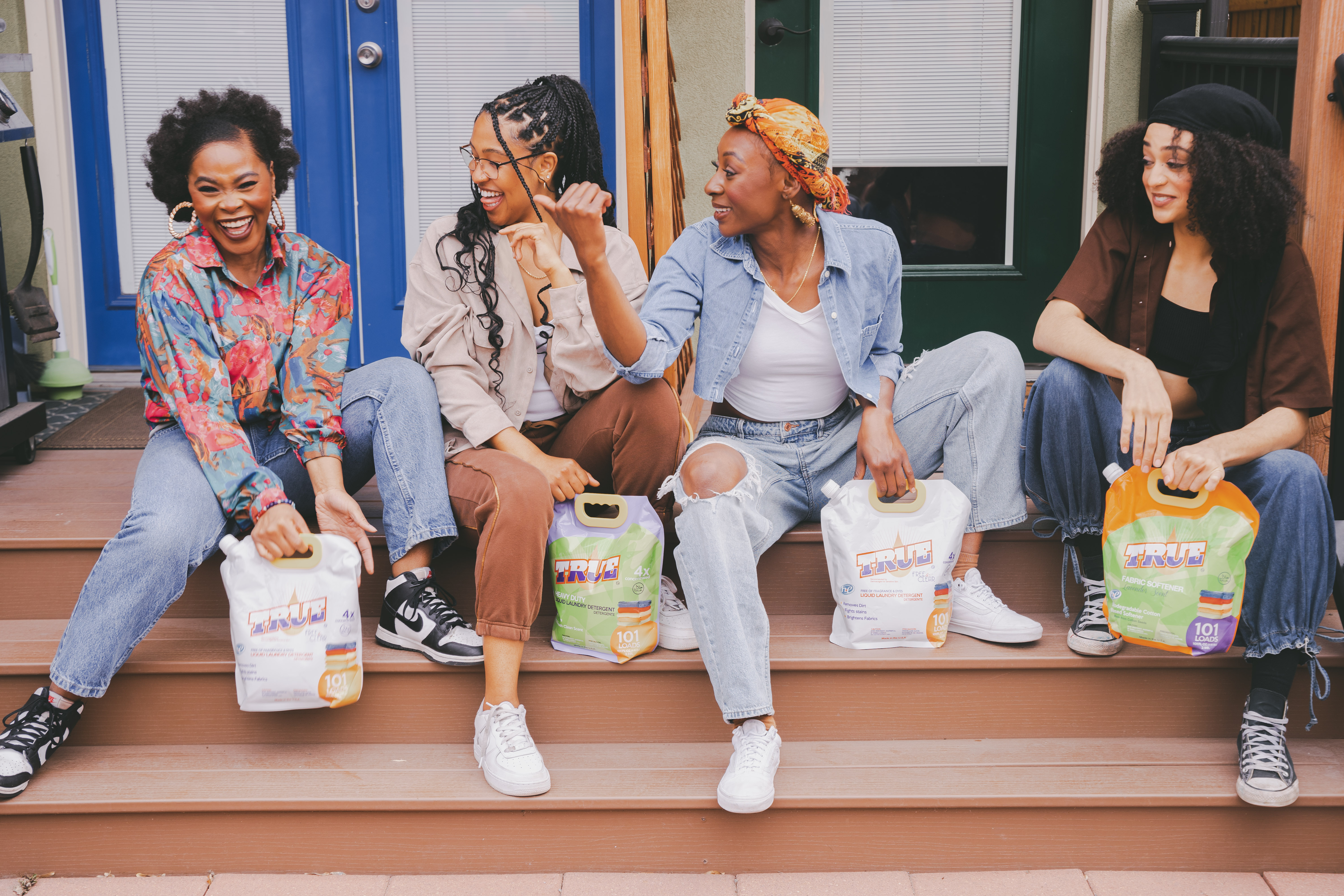 Four women with True Laundry products
