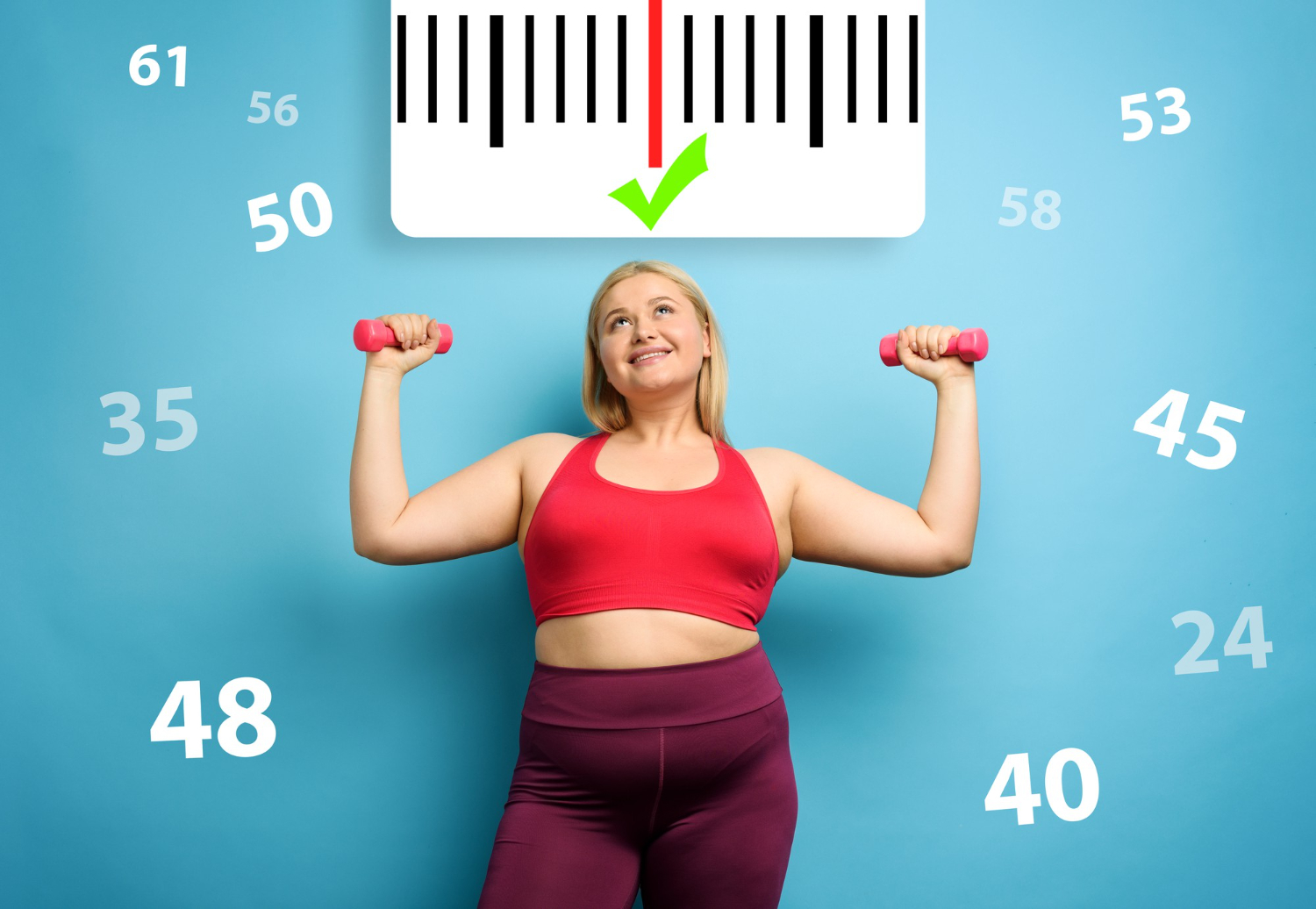 A woman wearing workout gear and holding small weights looks up at a tape measure above her head, celebrating hitting her weight loss goals.