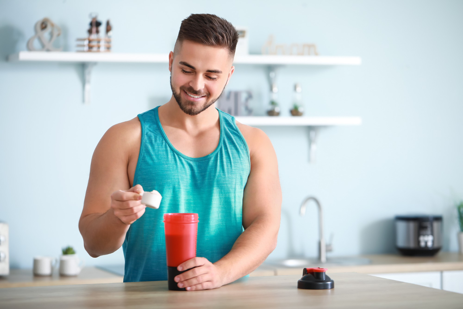 A man mixes a protein shake.