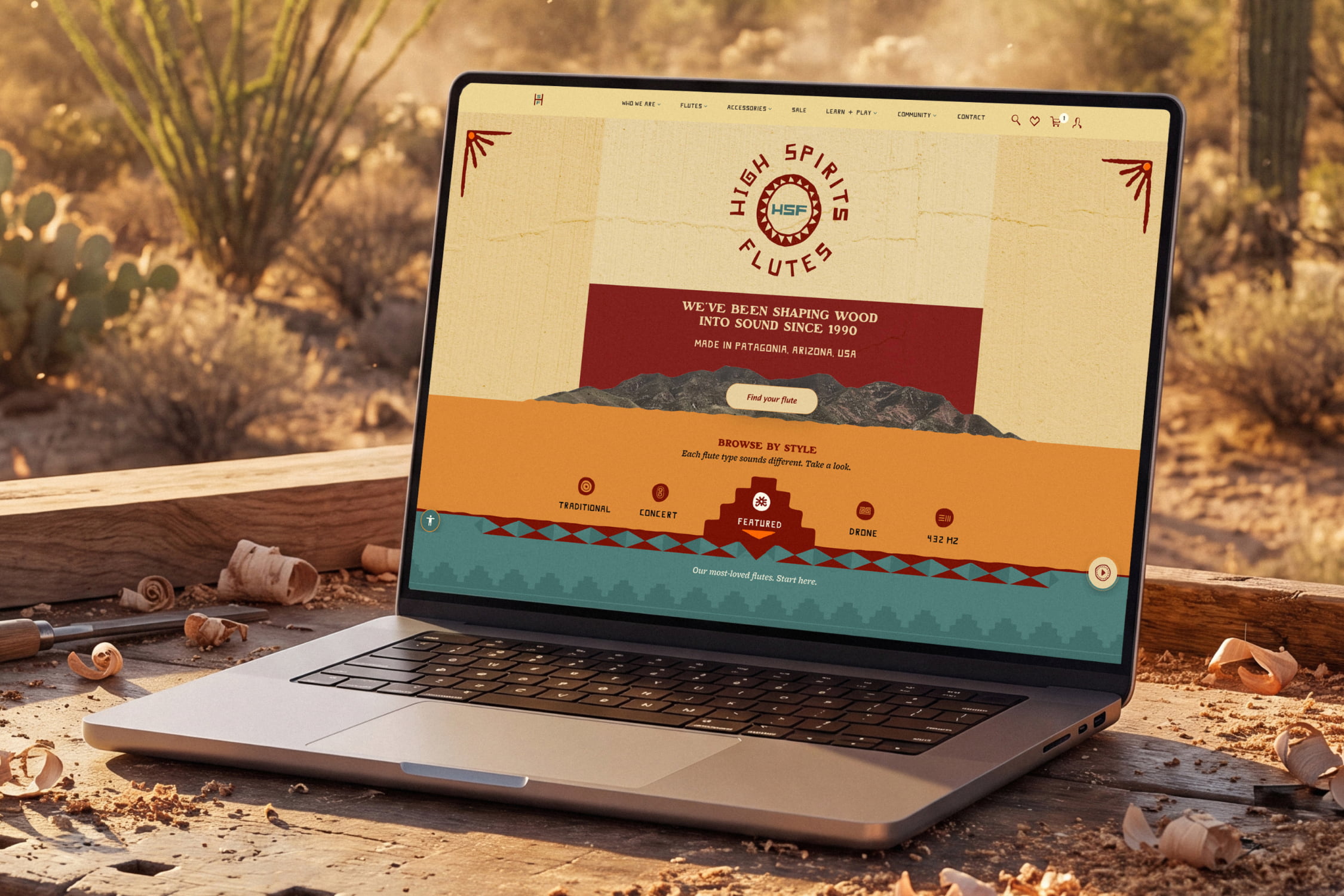 The custom High Spirits Flutes homepage open on a laptop set on a woodworker's bench with fresh shavings in the Arizona high desert.