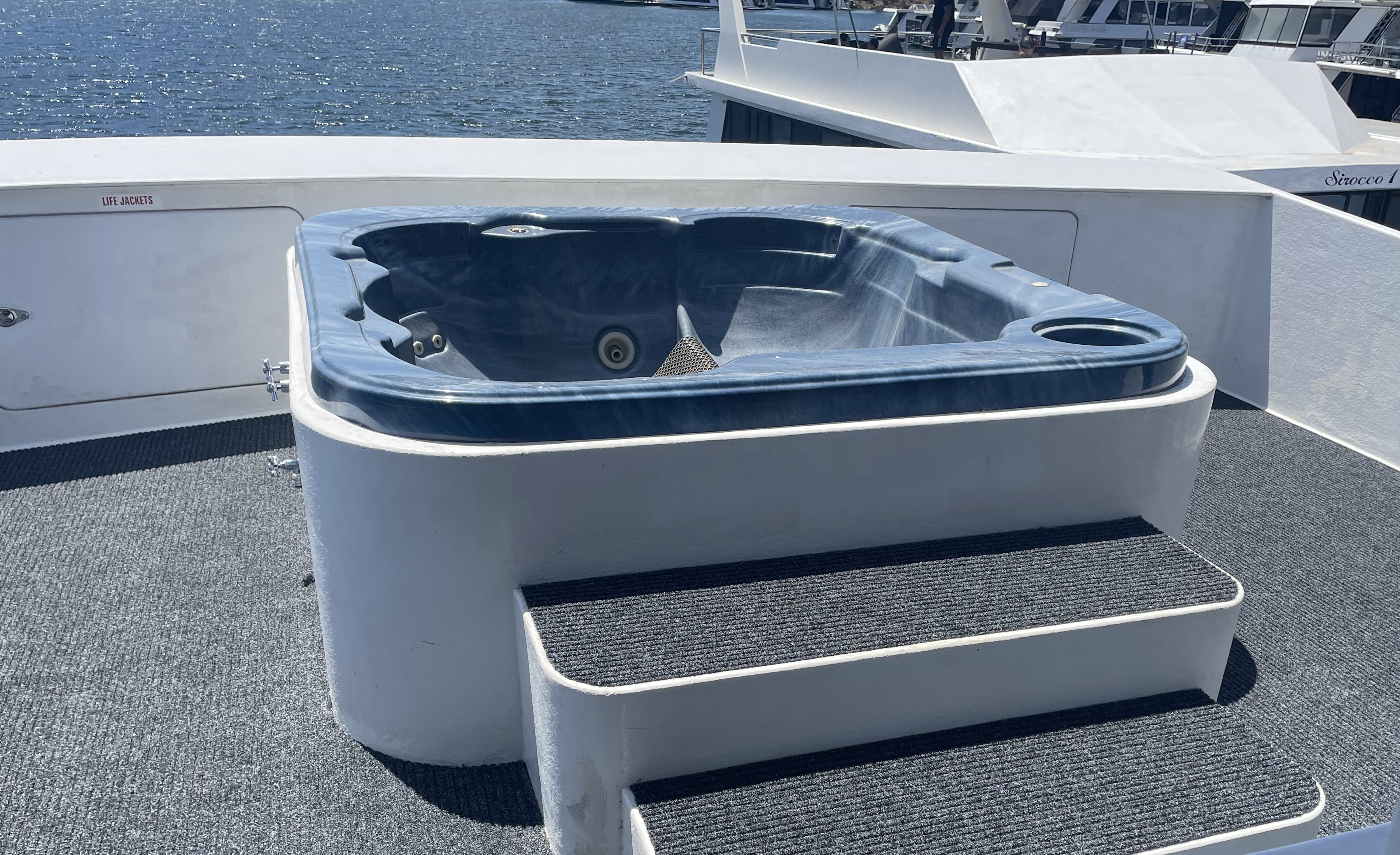 Rooftop spa with steps up, overlooking the lake and the neighbouring Sirocco houseboat.