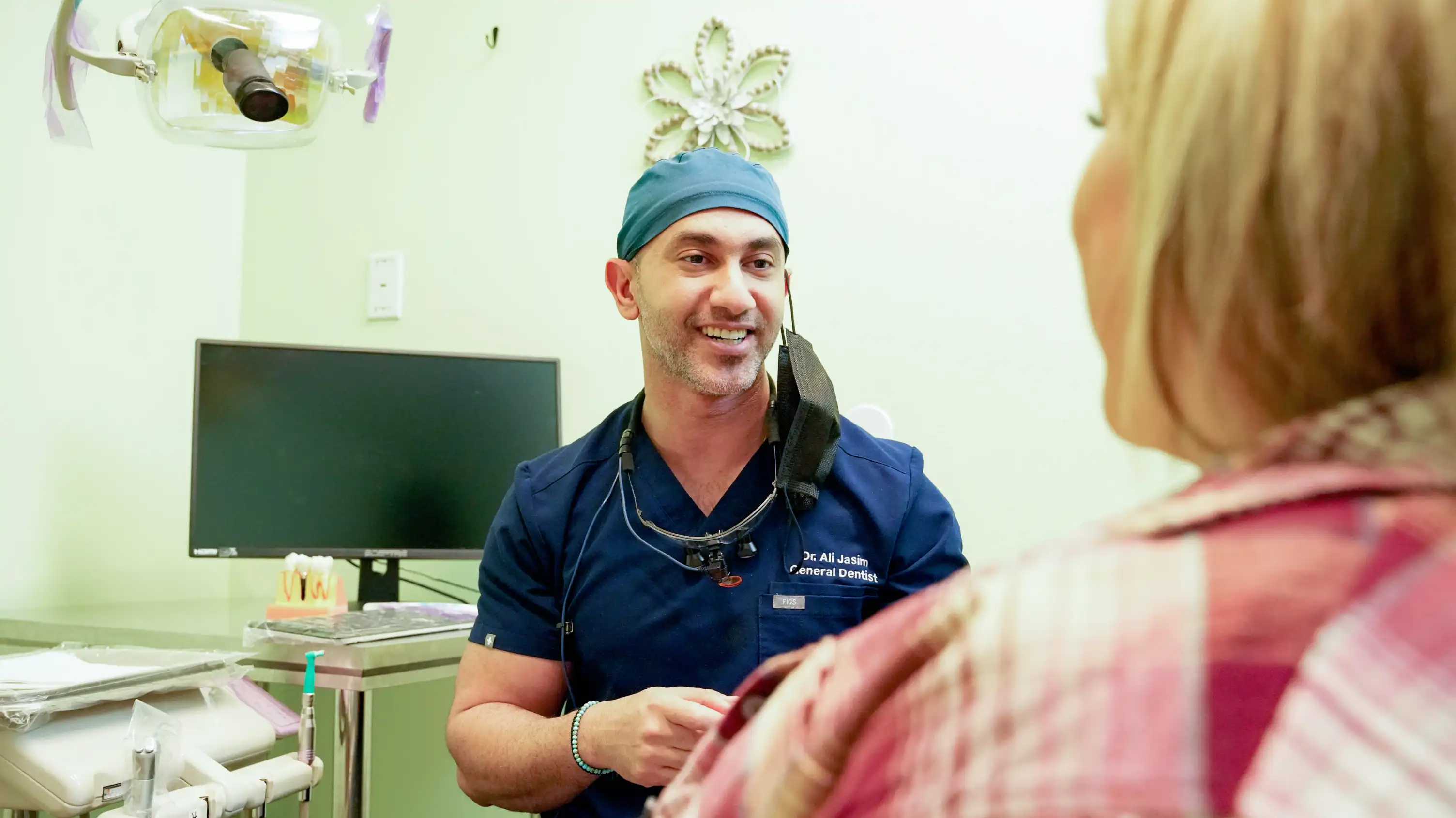 Dentist consulting with patient