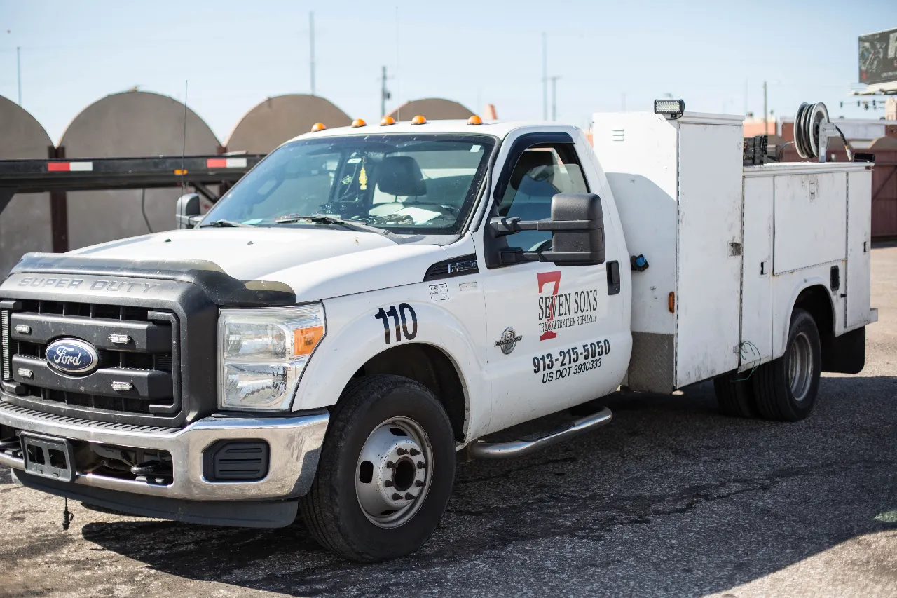 Mobile truck repair service truck, Ford Super Duty service body with Seven Sons Truck & Trailer Repair, unit 110 and 913-215-5050 displayed.