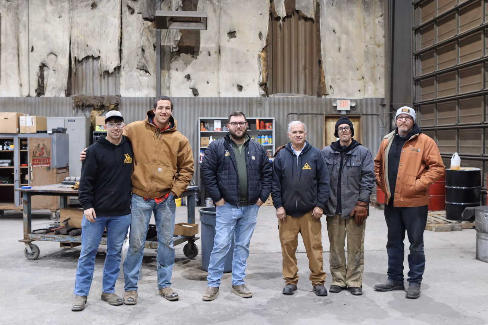 Multiple TSR employees standing in a warehouse smiling