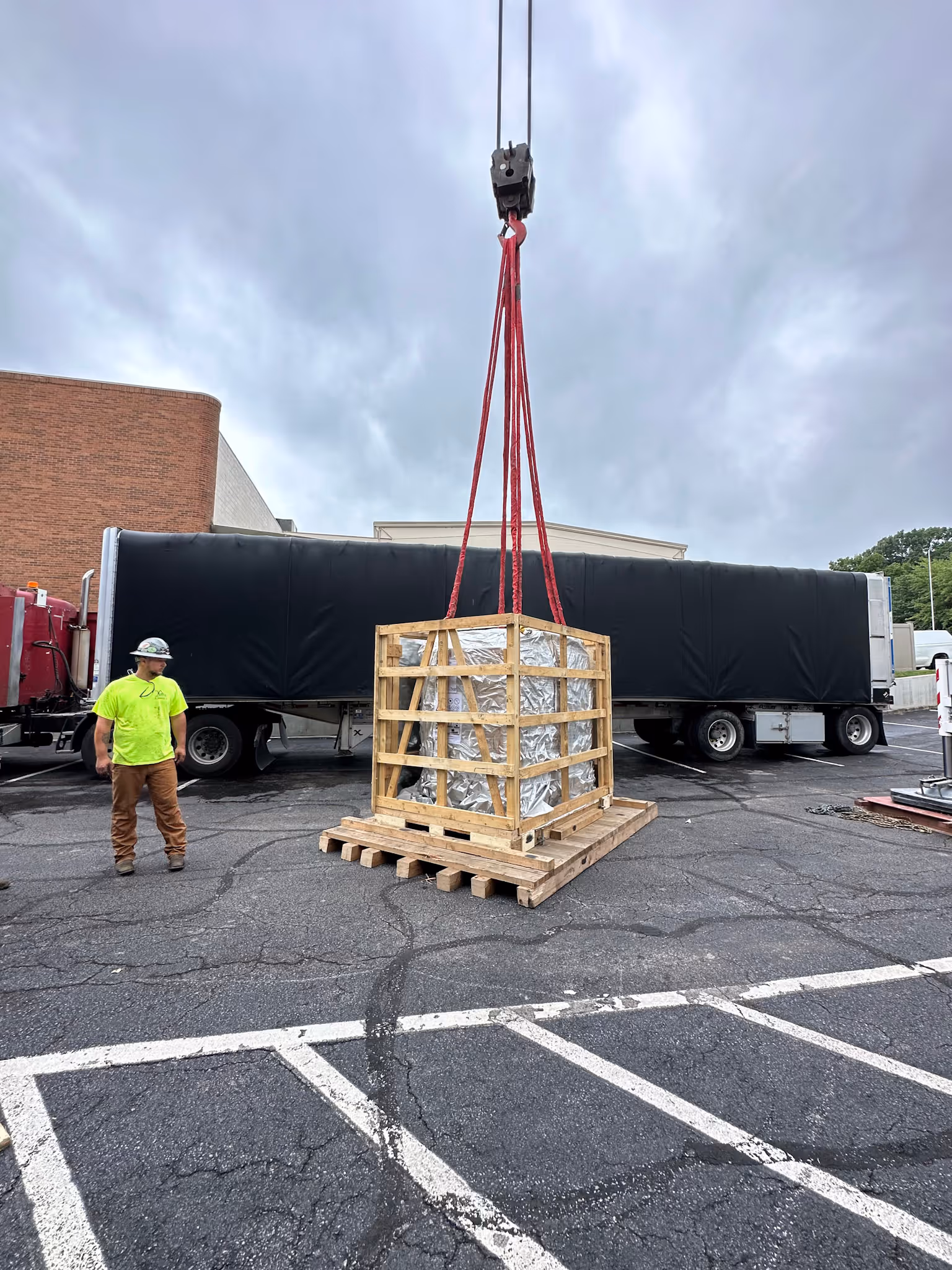 Medical equipment being set on the ground by a mobile crane
