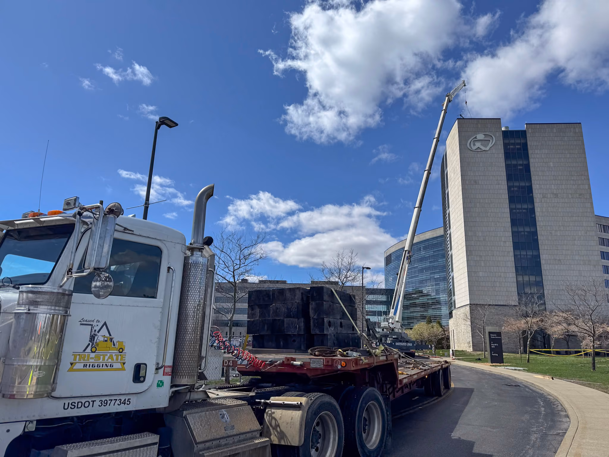 A TSR truck positioned in front of a boom truck crane lift at Owensboro's hospital