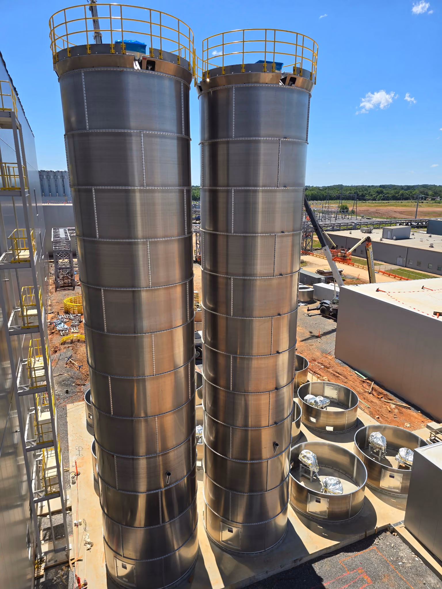 Steel silos outside a facility expansion after being placed