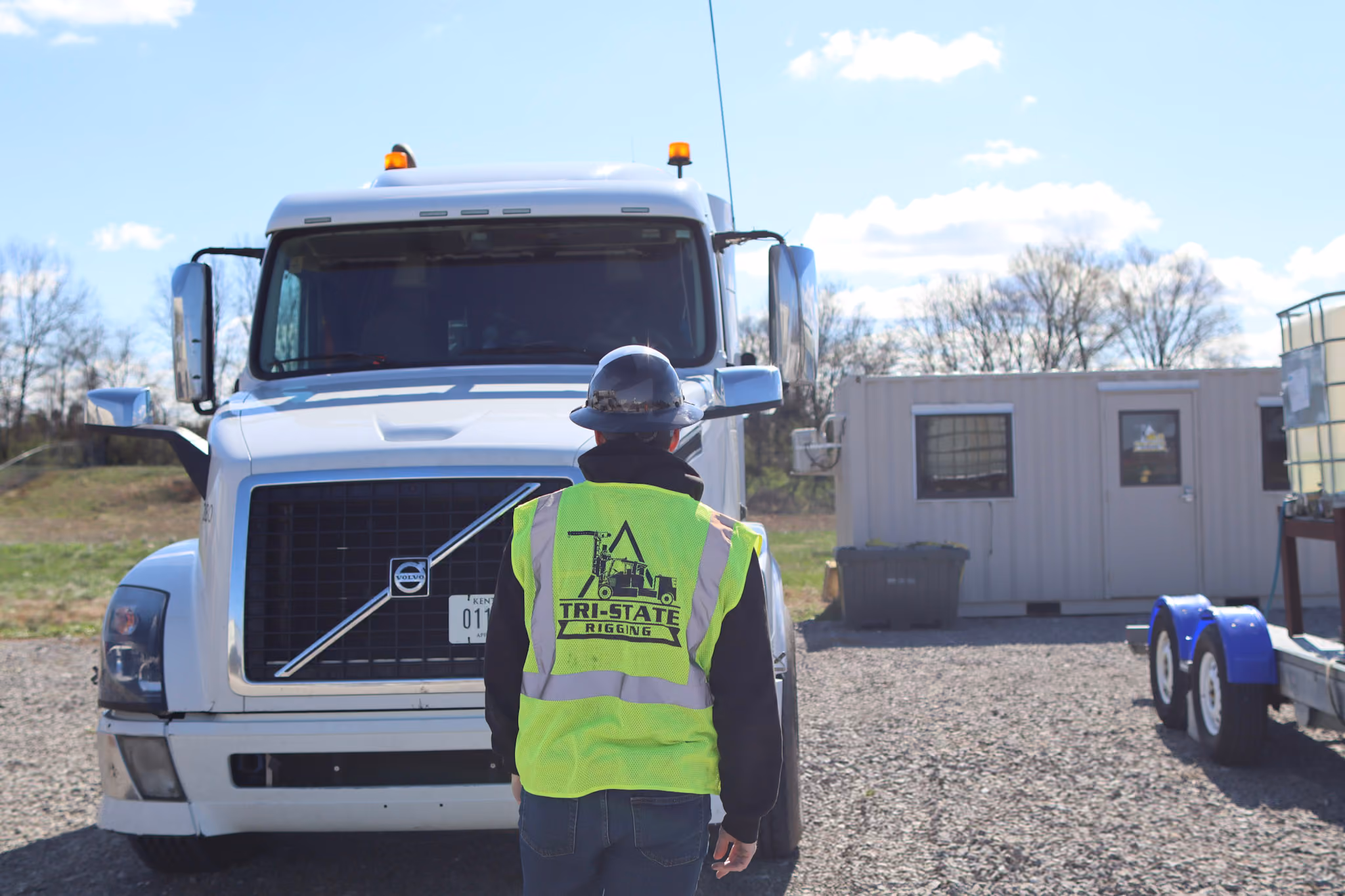 Two TSR epmloyees standing in front of a Terex boom truck crane