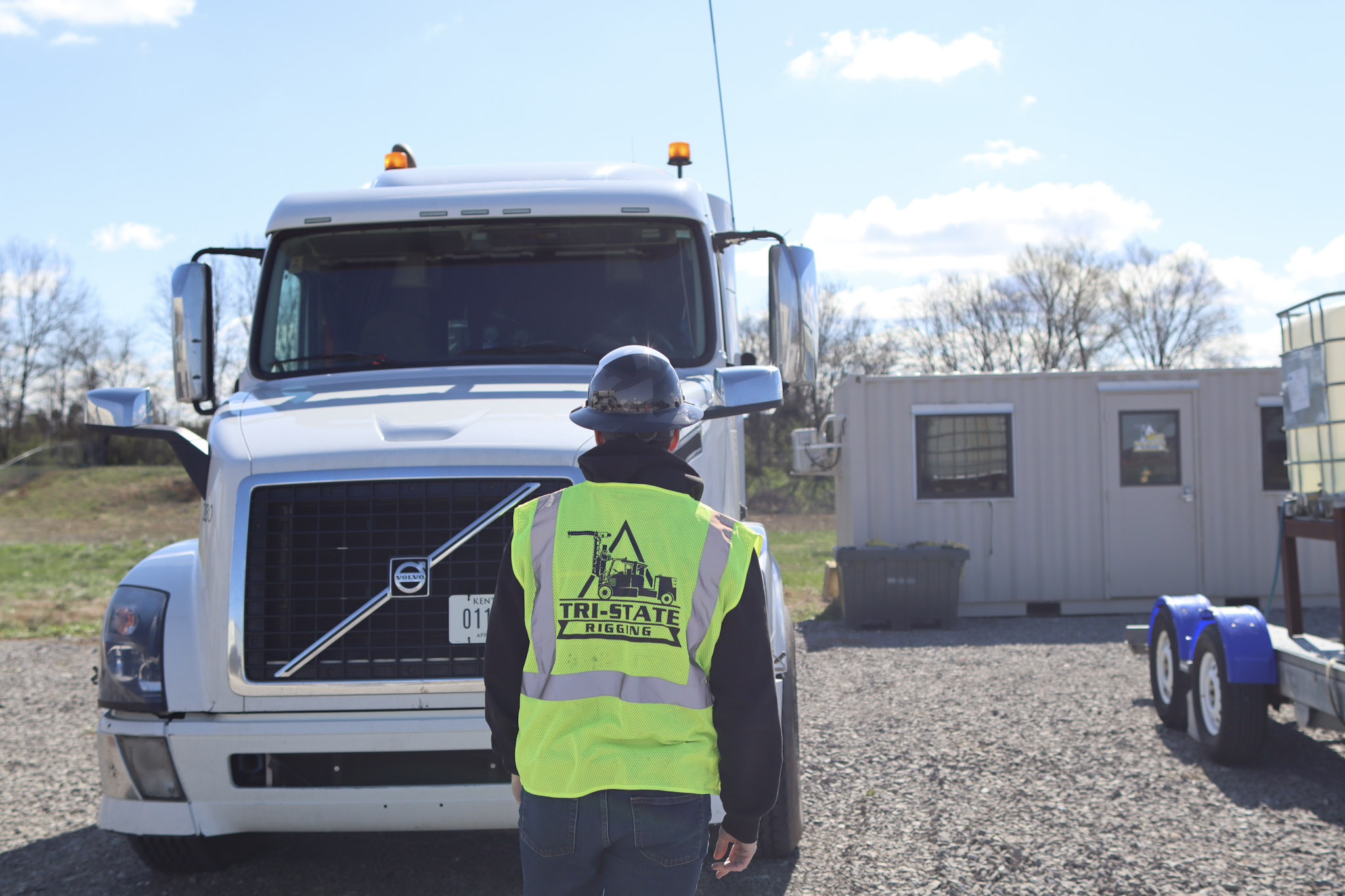 Two TSR epmloyees standing in front of a Terex boom truck crane