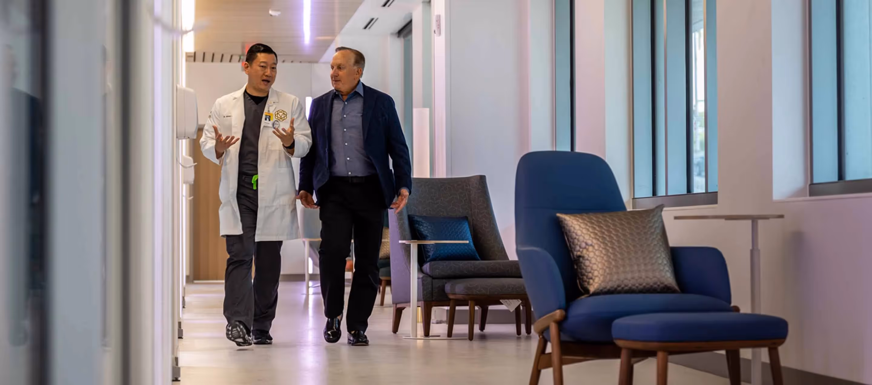 Anthony Chang and Doug Meijer walking along a hallway in the Doug Meijer Medical Innovation Building
