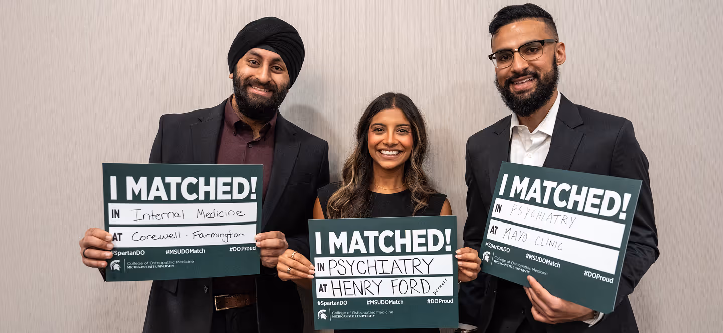 Three medical graduates standing indoors, smiling and holding signs that read “I Matched!” with residency placements in internal medicine and psychiatry at Corewell Health–Farmington, Henry Ford, and Mayo Clinic.