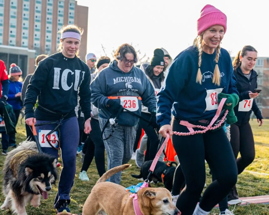 Runners and their dogs begin the IRONDOG 5K in 2025.