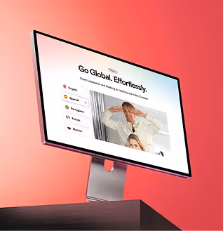 Computer monitor displaying a language translation interface with options for English, Spanish, Portuguese, French, and Russian, and a photo of two people behind the options.