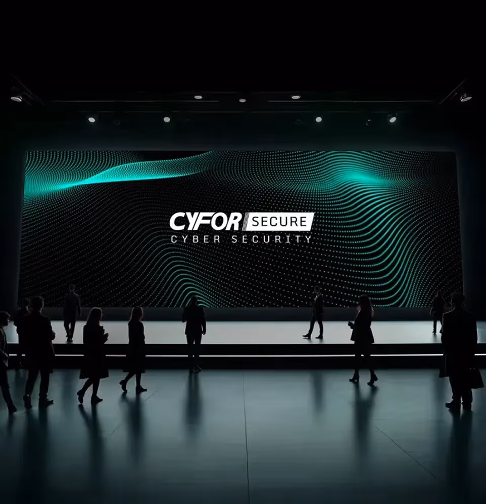 Silhouettes of people standing and walking in front of a large screen displaying the text 'CYFOR SECURE CYBER SECURITY' with abstract green wave patterns.