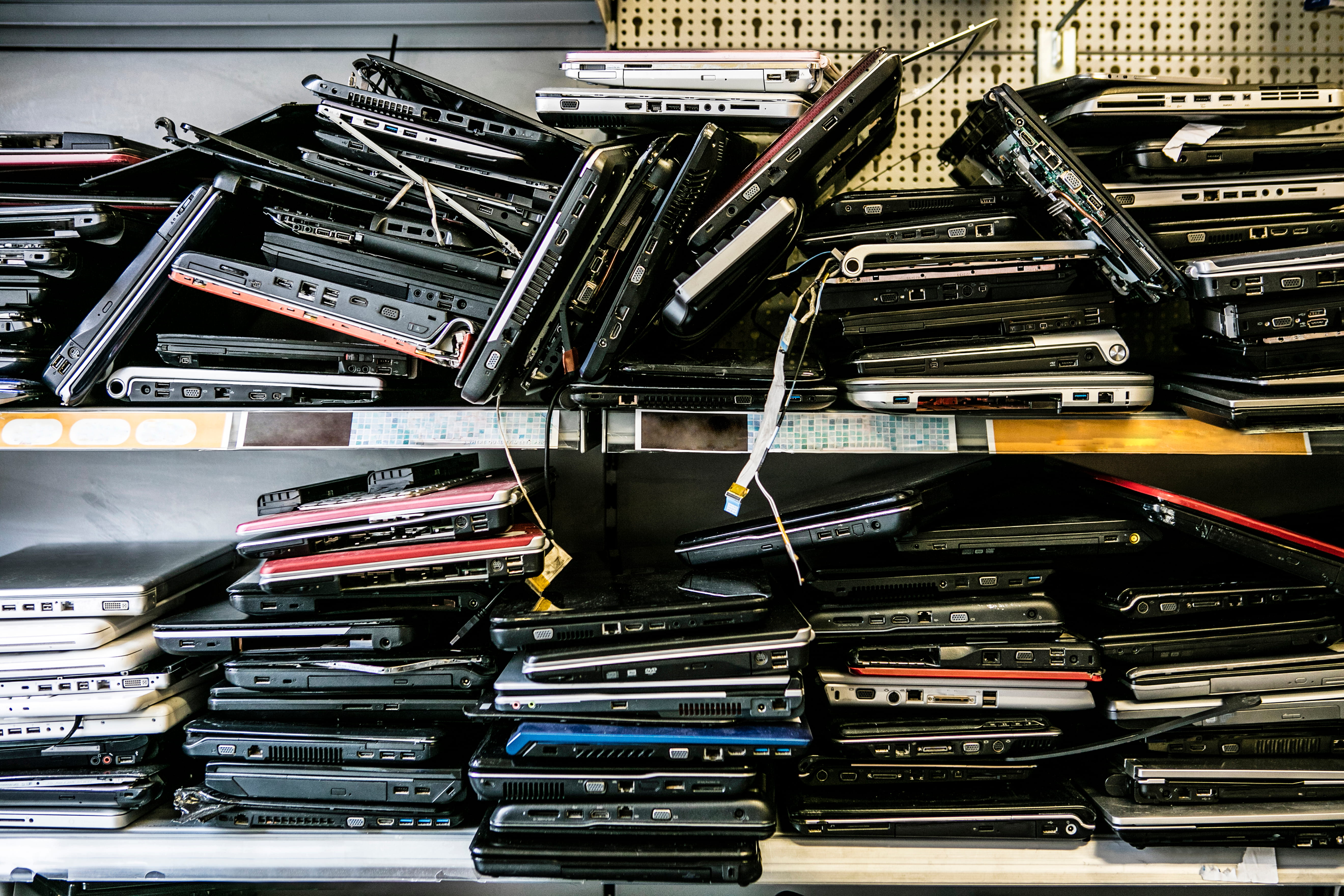 Stacked obsolete laptops collected by an e-waste recycling company in Singapore